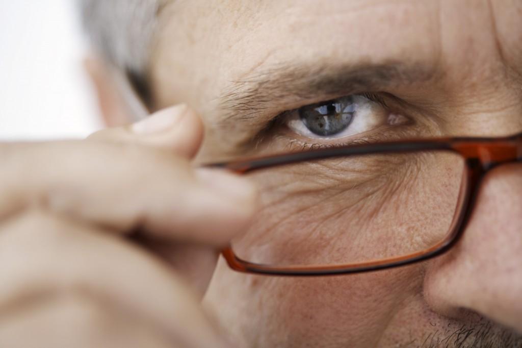man looking over glasses