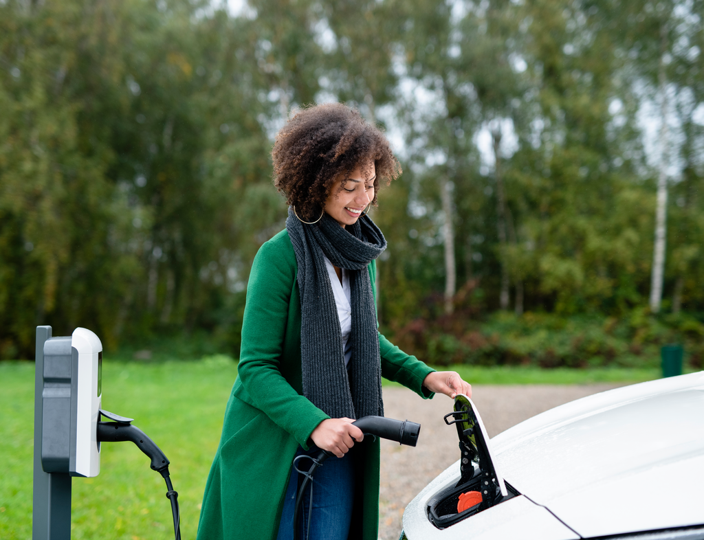 Woman charging an electric car